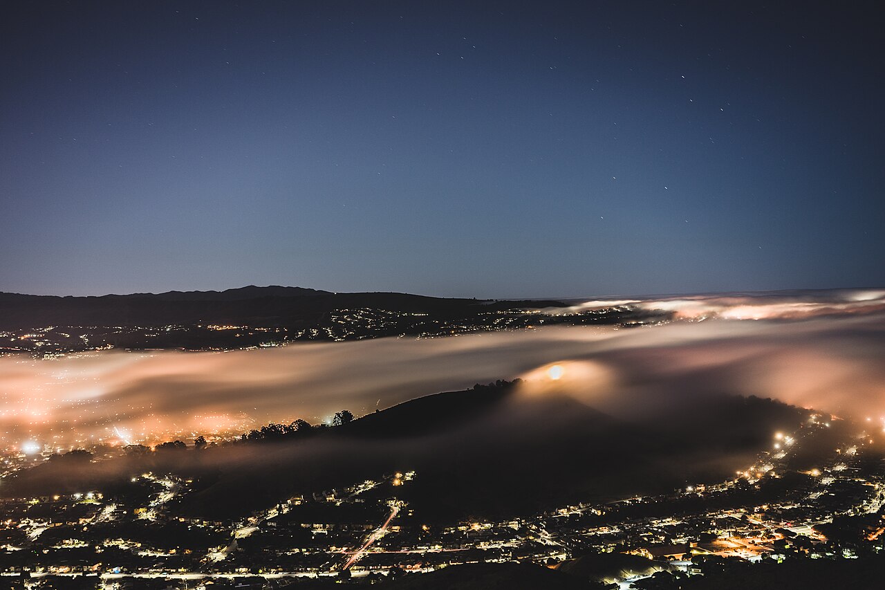 Brisbane California homes and illuminated stars below San Bruno Mountain